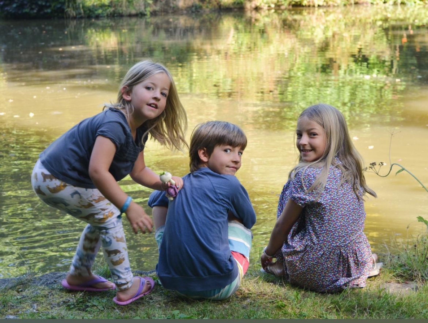 Rosie as a child with her siblings by the pond