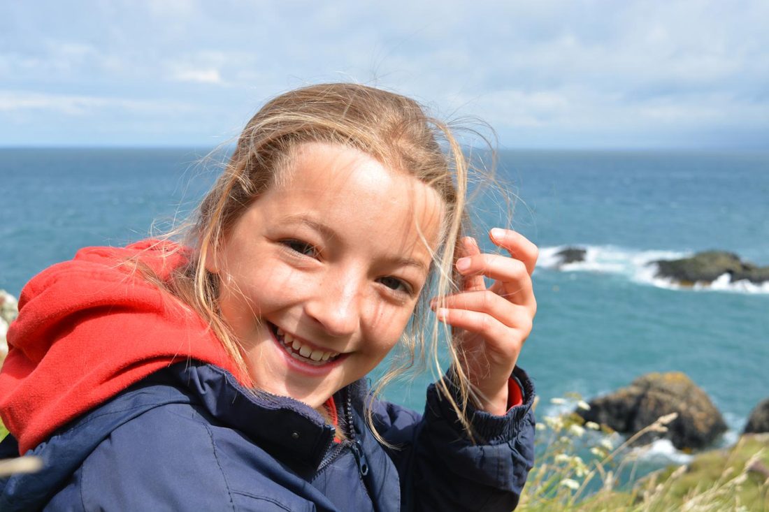 Rosie smiling by the sea